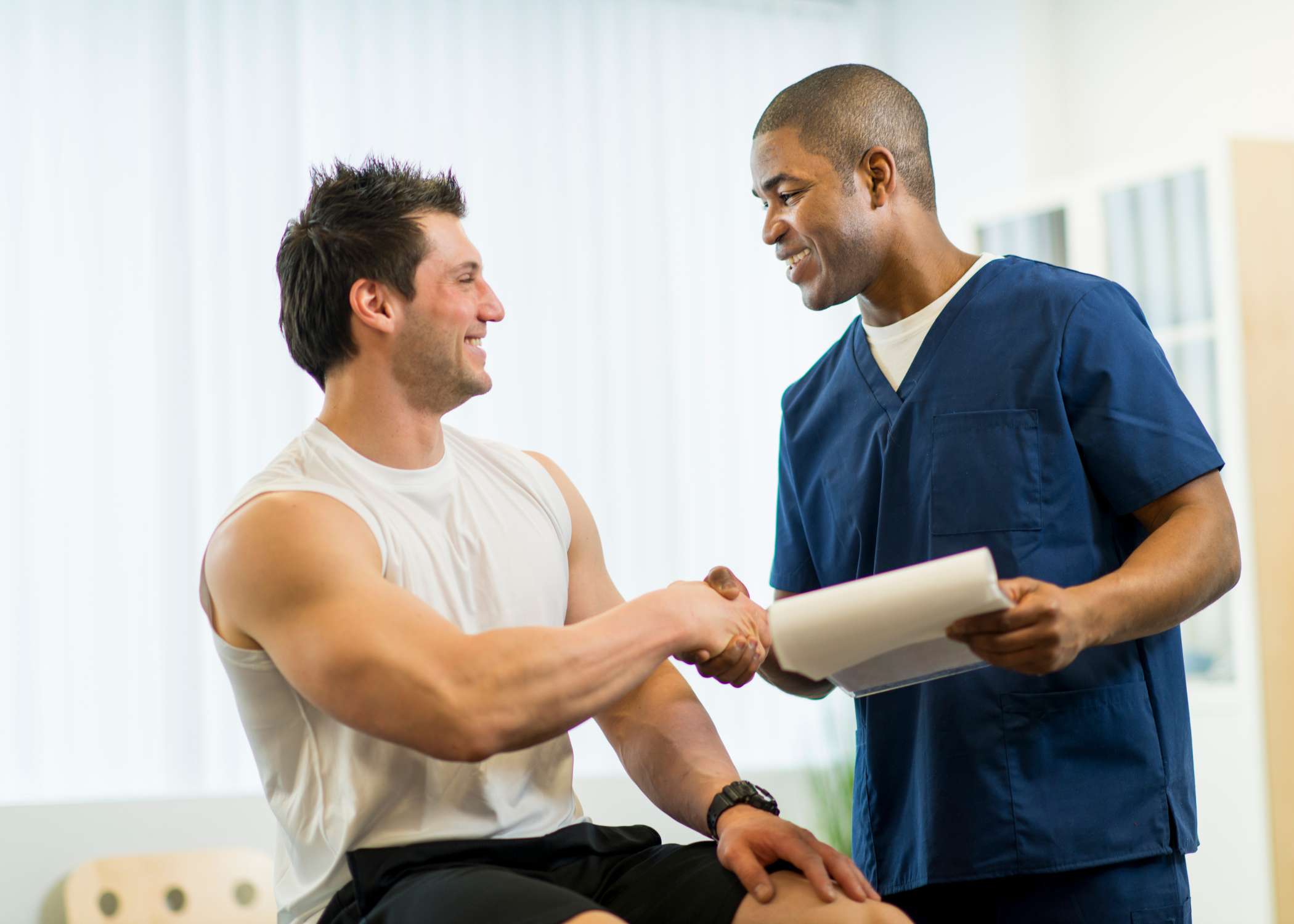 man and a therapist shaking hands - Capstone Physical Therapy and Fitness